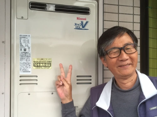 給湯器のまえでピースするお客さま